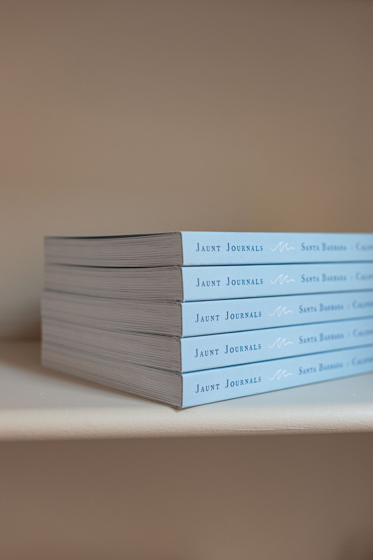 An image of Jaunt Journals guidebooks stacked on top of each other.