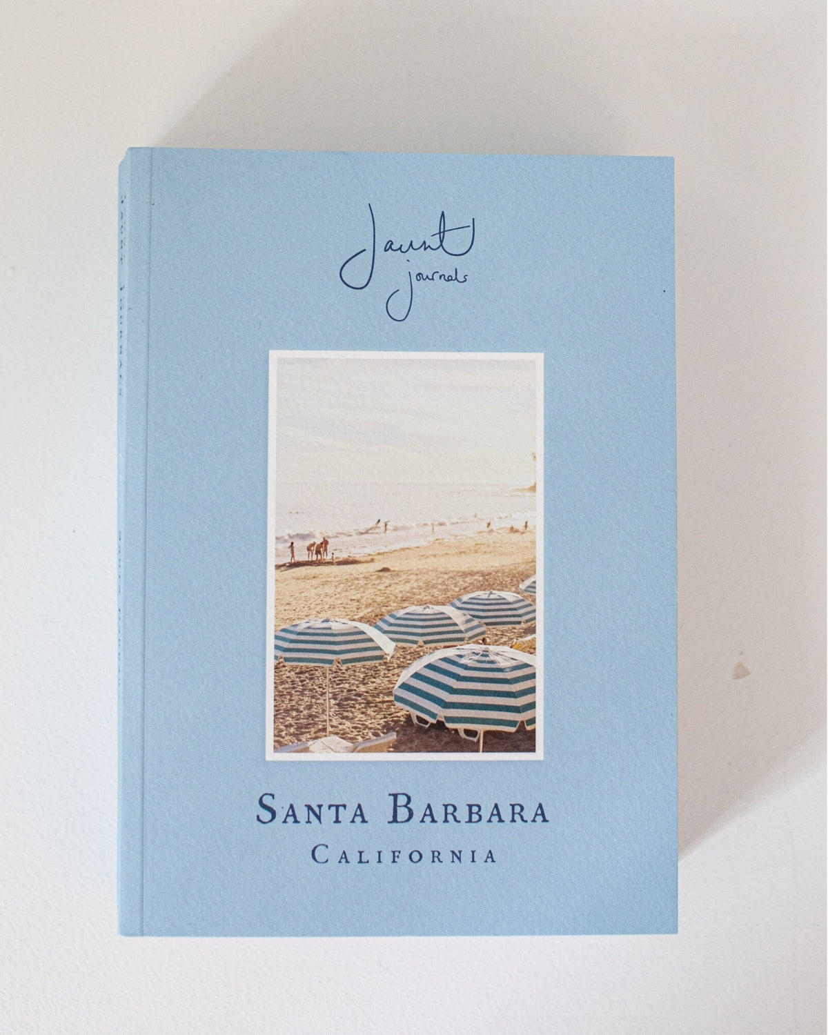 Jaunt Journals Santa Barbara + Guide book cover + Santa Barbara beach with umbrellas, blue book cover